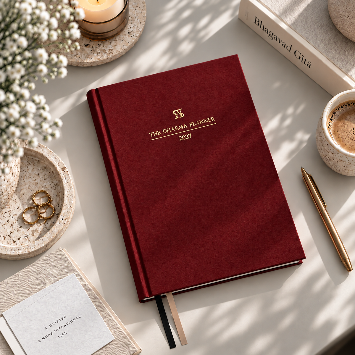 The Dharma Planner 2027, deep red linen cover with gold foil lettering.